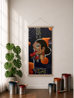 A vertical rolled canvas art print featuring an abstract portrait of a woman with other art elements like red flowers, orange and purple shapes, white curved organic lines, leaves hanging from white branches, 2 paint brushes with purple paint on it, and a dark navy background. The art piece is displayed hung on a wall in a styled room with a plant, paint cans, and window shadows as well as white linen curtains on the left side of the display.