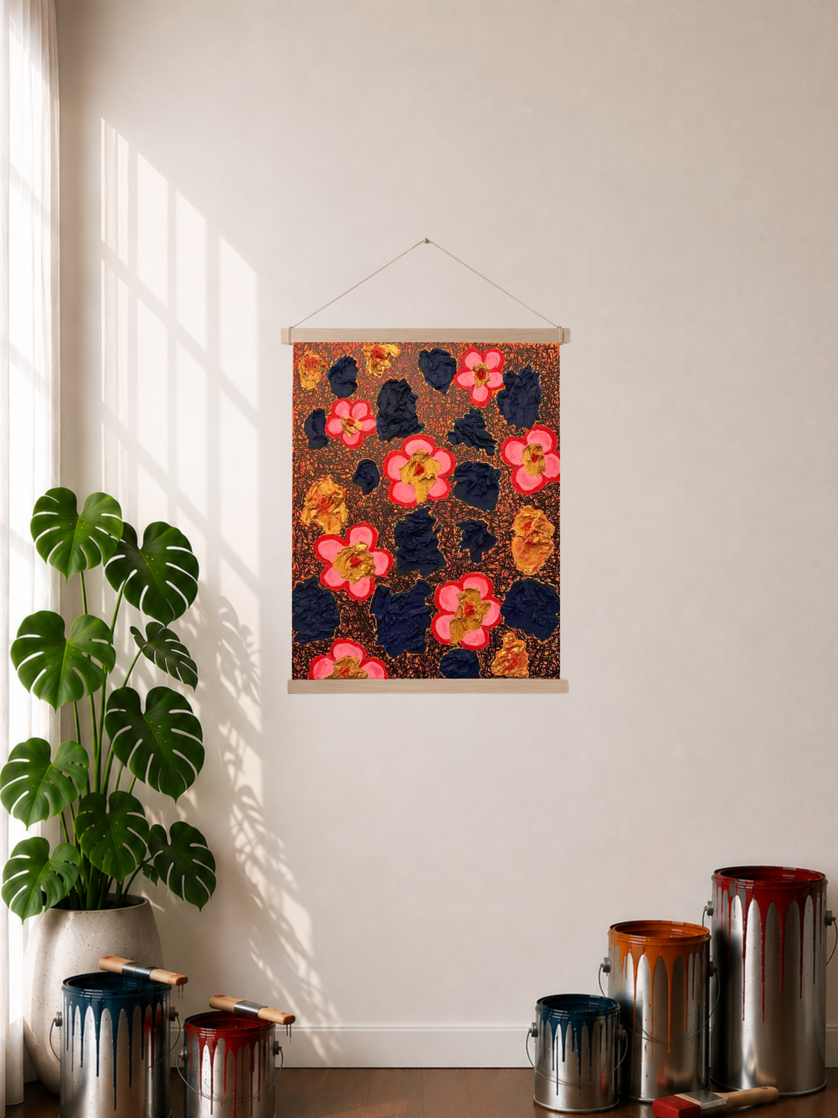 A Rolled-out Canvas print featuring an abstract art piece displayed on a wall in a styled room with a plant, paint cans, and window shadows in the display. The art image has blue abstract clusters laying on top of an orange background with black abstract line art. There are also gold-colored abstract clusters that have a red dot stroke like accent in the middle of each cluster. Another element is the pop art pink flowers with a red border on the petals and a gold core with a red dot.